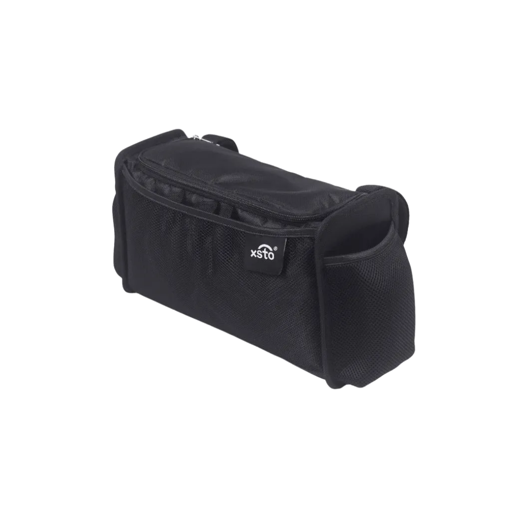 The XSTO Side Storage Bag for M4 Powerchair is a durable black rectangular bag with side pockets, a top zipper, and front XSTO logo—an ideal wheelchair accessory. Shown on a white background.